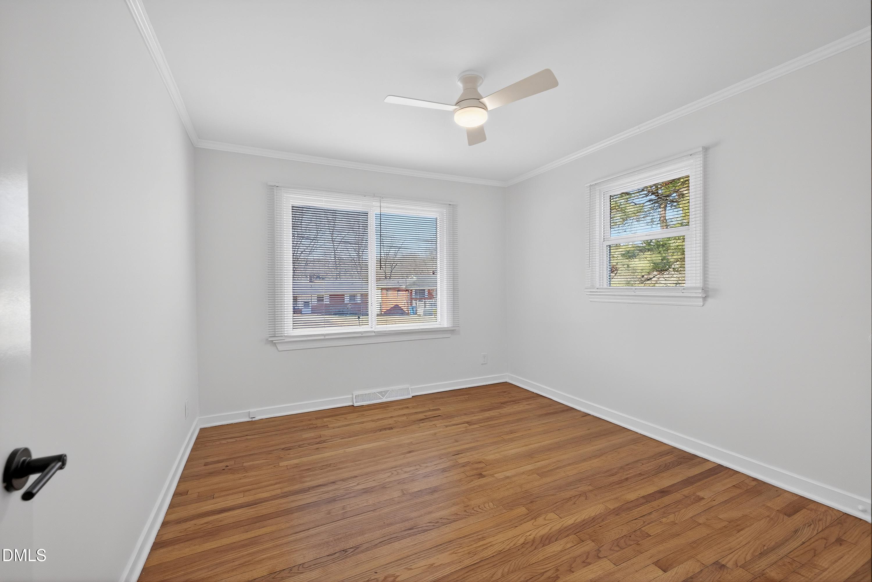 302 Normandy Street Durham, NC 27707 - Photo 25 of 29 a view of an empty room with wooden floor and a window