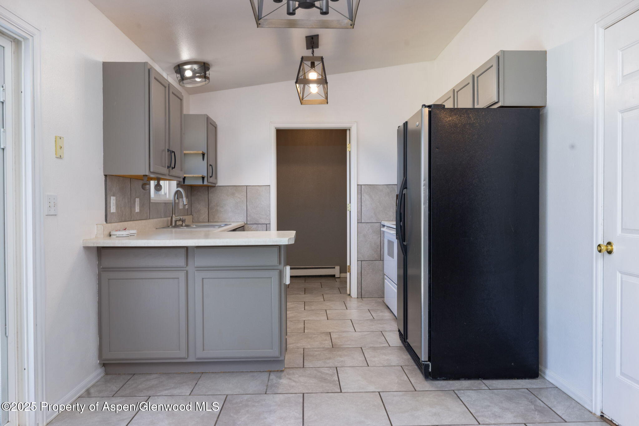 482 Fox Run Clifton, CO 81520 - Photo 17 of 25 a kitchen with a sink refrigerator and cabinets