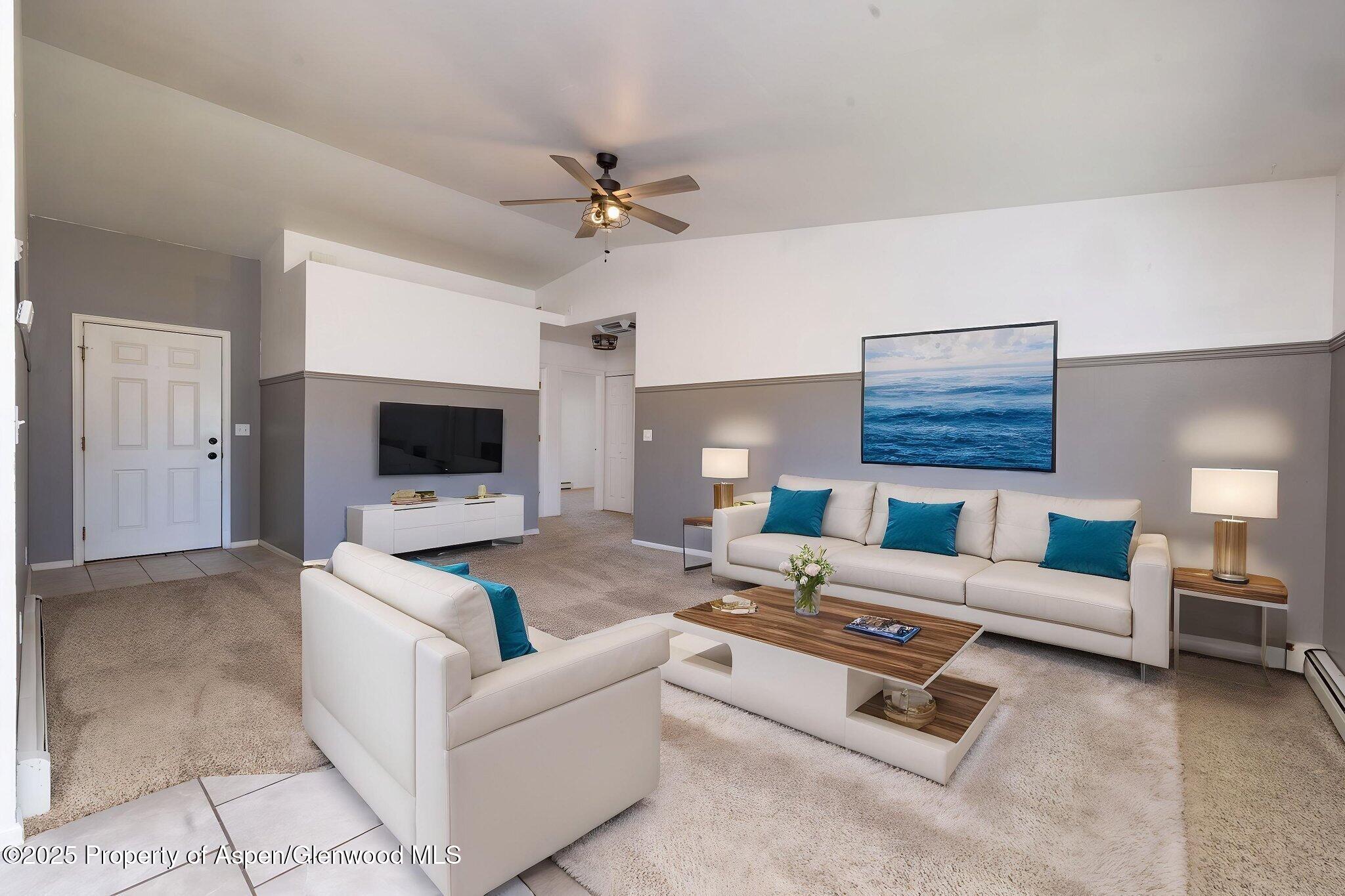 482 Fox Run Clifton, CO 81520 - Photo 20 of 25 a living room with furniture a flat screen tv and a fireplace