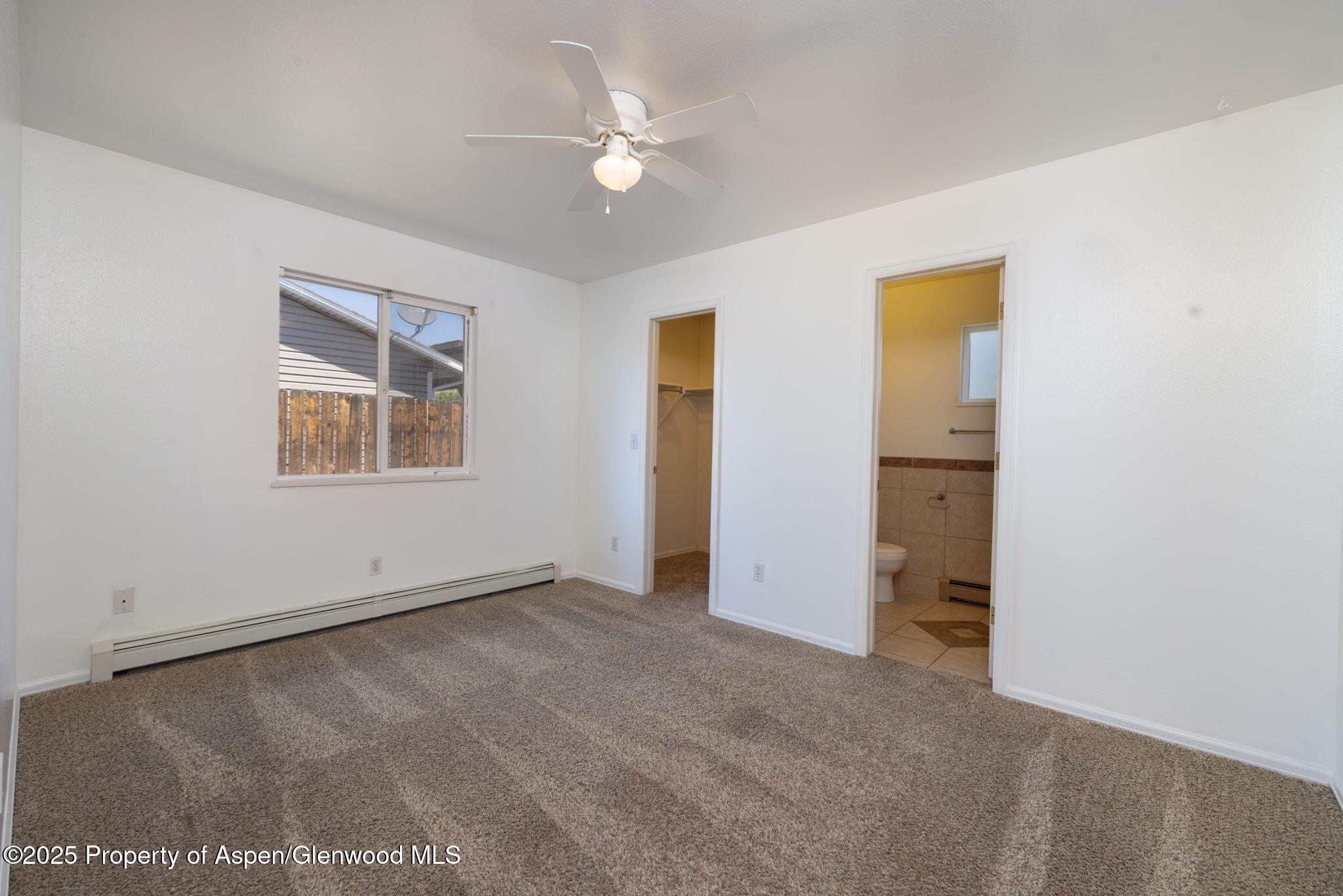 482 Fox Run Clifton, CO 81520 - Photo 5 of 25 an empty room with windows and ceiling fan