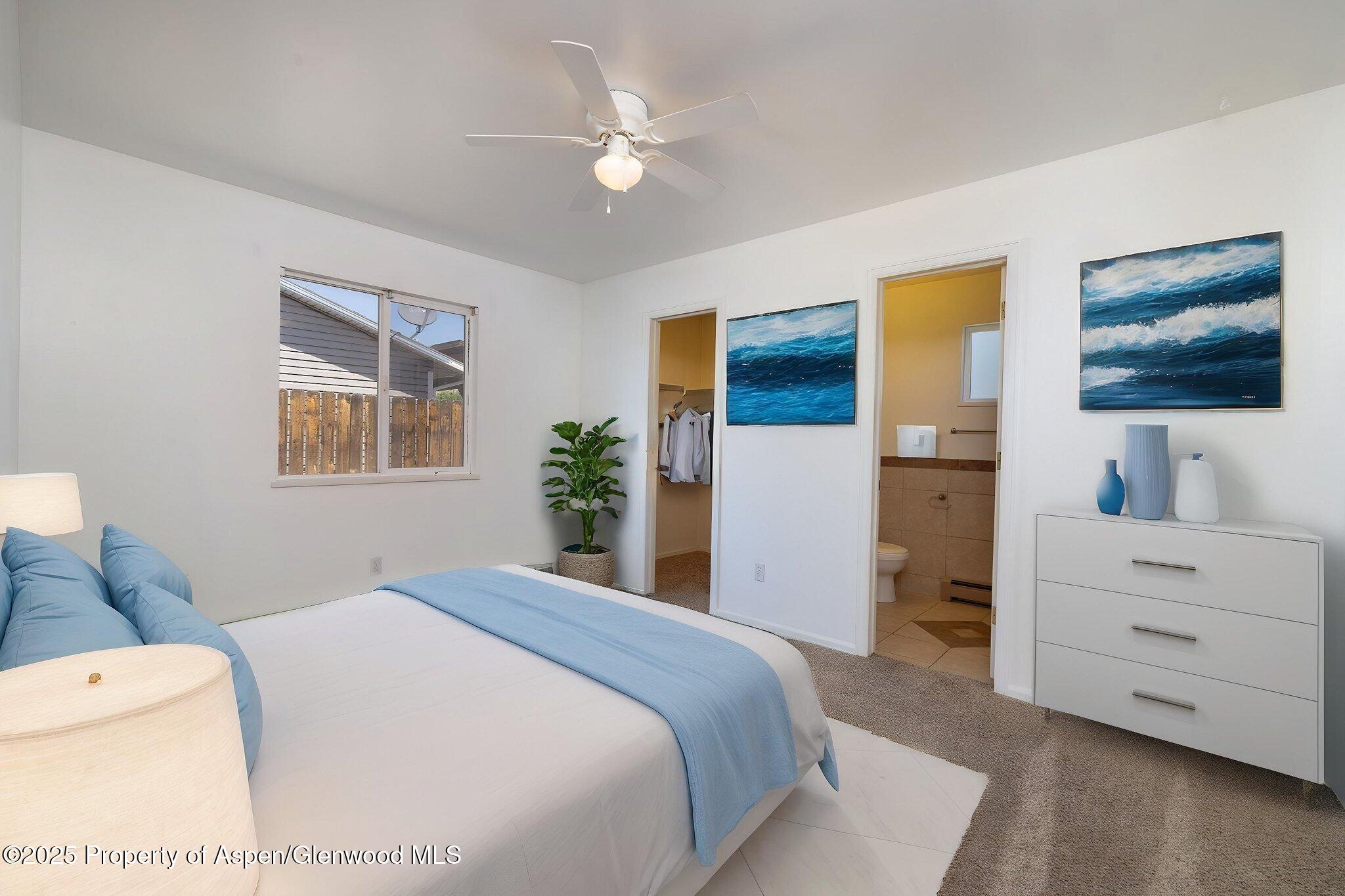 482 Fox Run Clifton, CO 81520 - Photo 6 of 25 a bedroom with a bed and a flat screen tv