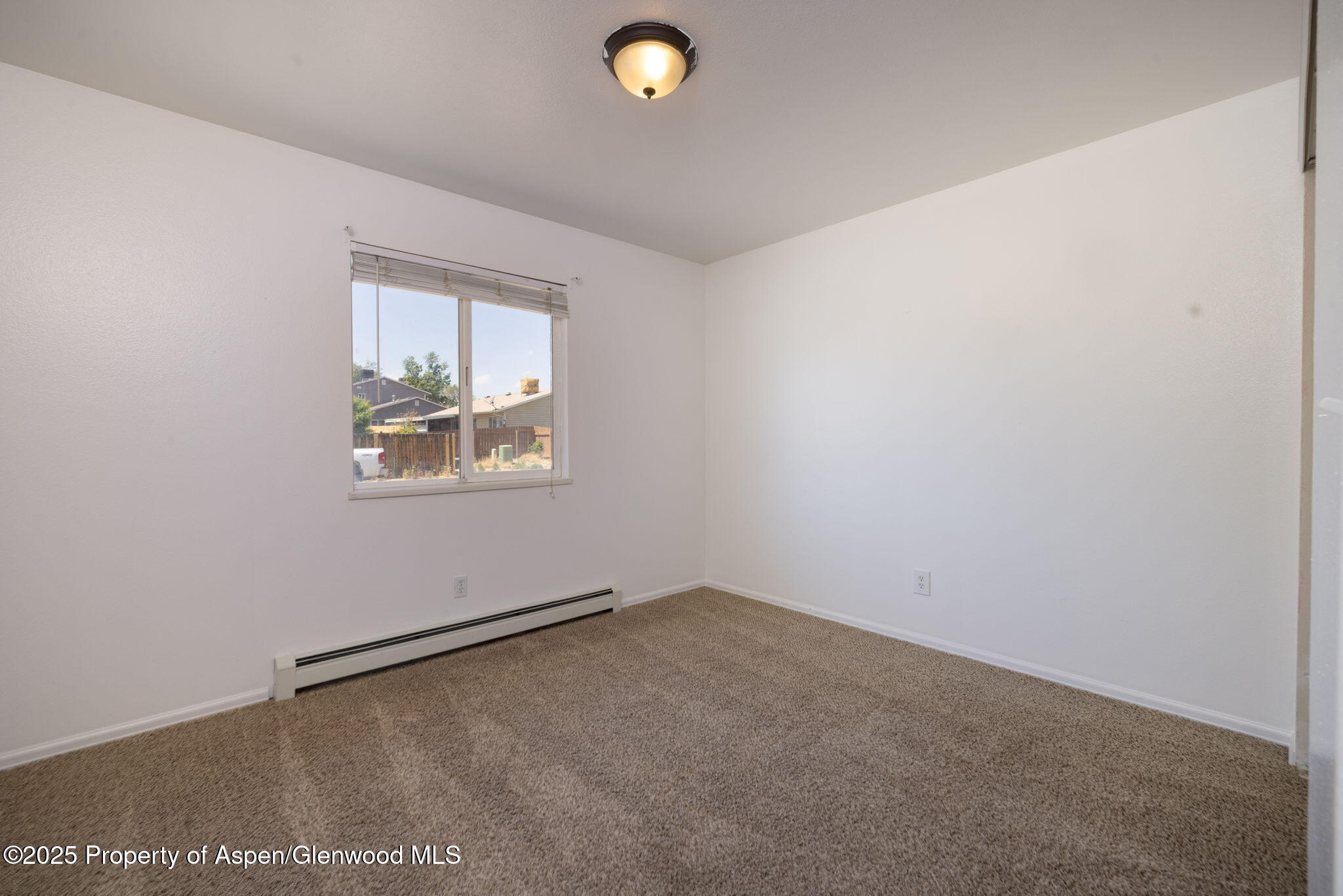 482 Fox Run Clifton, CO 81520 - Photo 10 of 25 an empty room with windows and cabinet