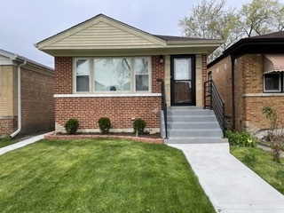 9042 South Lowe Avenue Chicago, IL 60620 - Photo 1 of 16 a front view of a house with a yard
