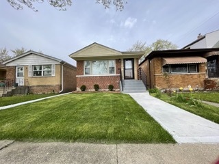 9042 South Lowe Avenue Chicago, IL 60620 - Photo 16 of 16 a front view of a house with a yard and potted plants