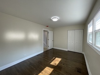 9042 South Lowe Avenue Chicago, IL 60620 - Photo 6 of 16 an empty room with wooden floor and windows