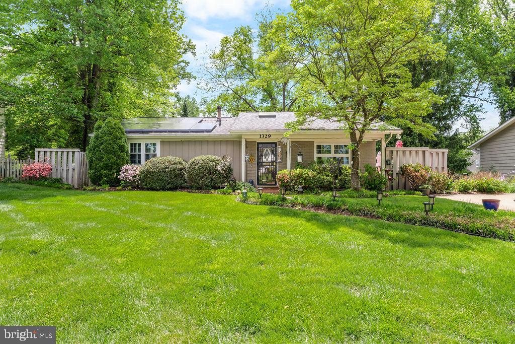a front view of house with yard and green space