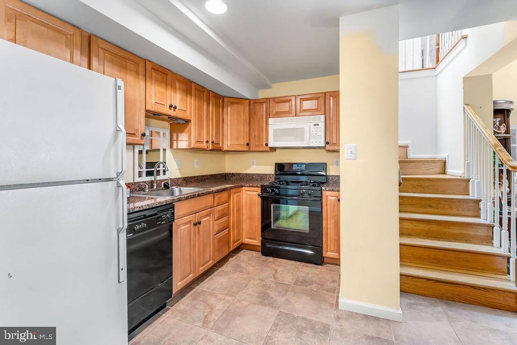 1329 Gresham Road Silver Spring, MD 20904 - Photo 32 of 56 a kitchen with stainless steel appliances granite countertop a refrigerator and a sink