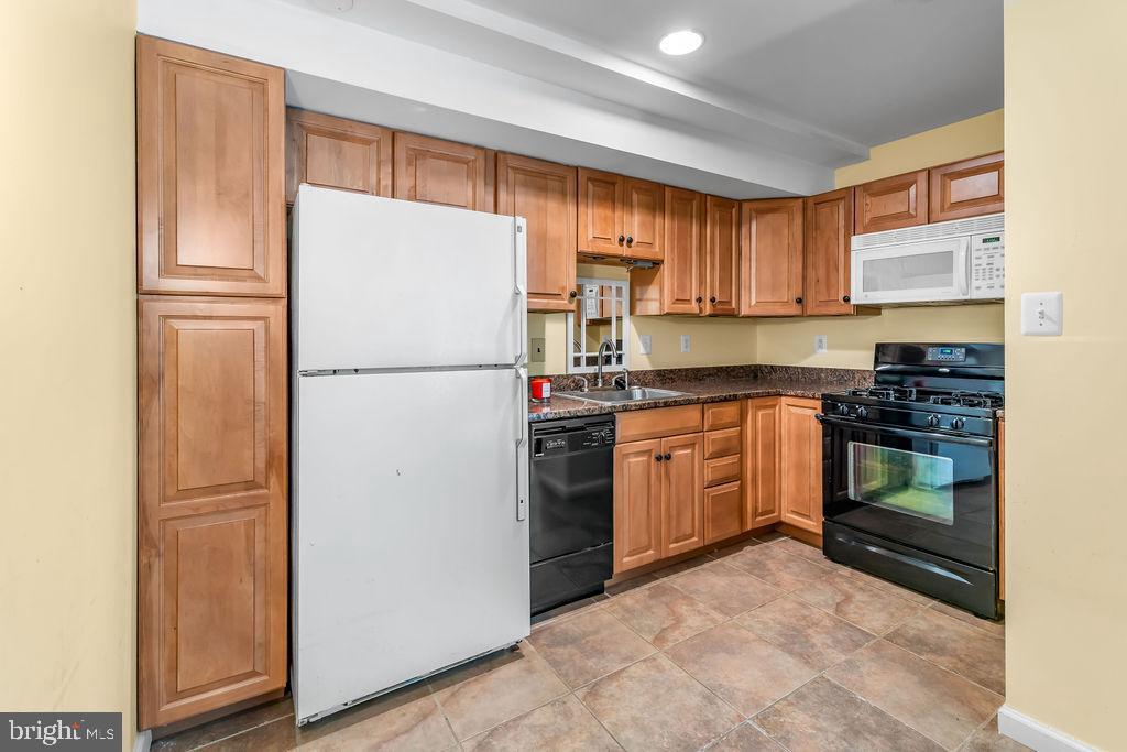 1329 Gresham Road Silver Spring, MD 20904 - Photo 33 of 56 a kitchen with a refrigerator stove and sink