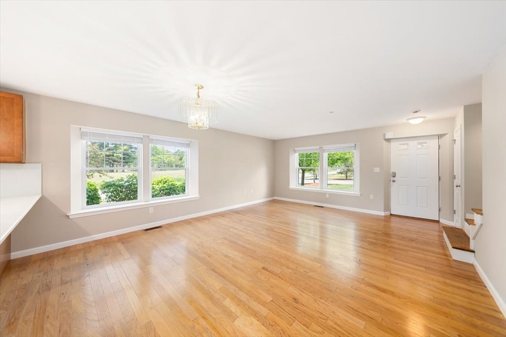 6 Bates Street, Unit A Devens, MA 01434 - Photo 12 of 41 an empty room with wooden floor and windows