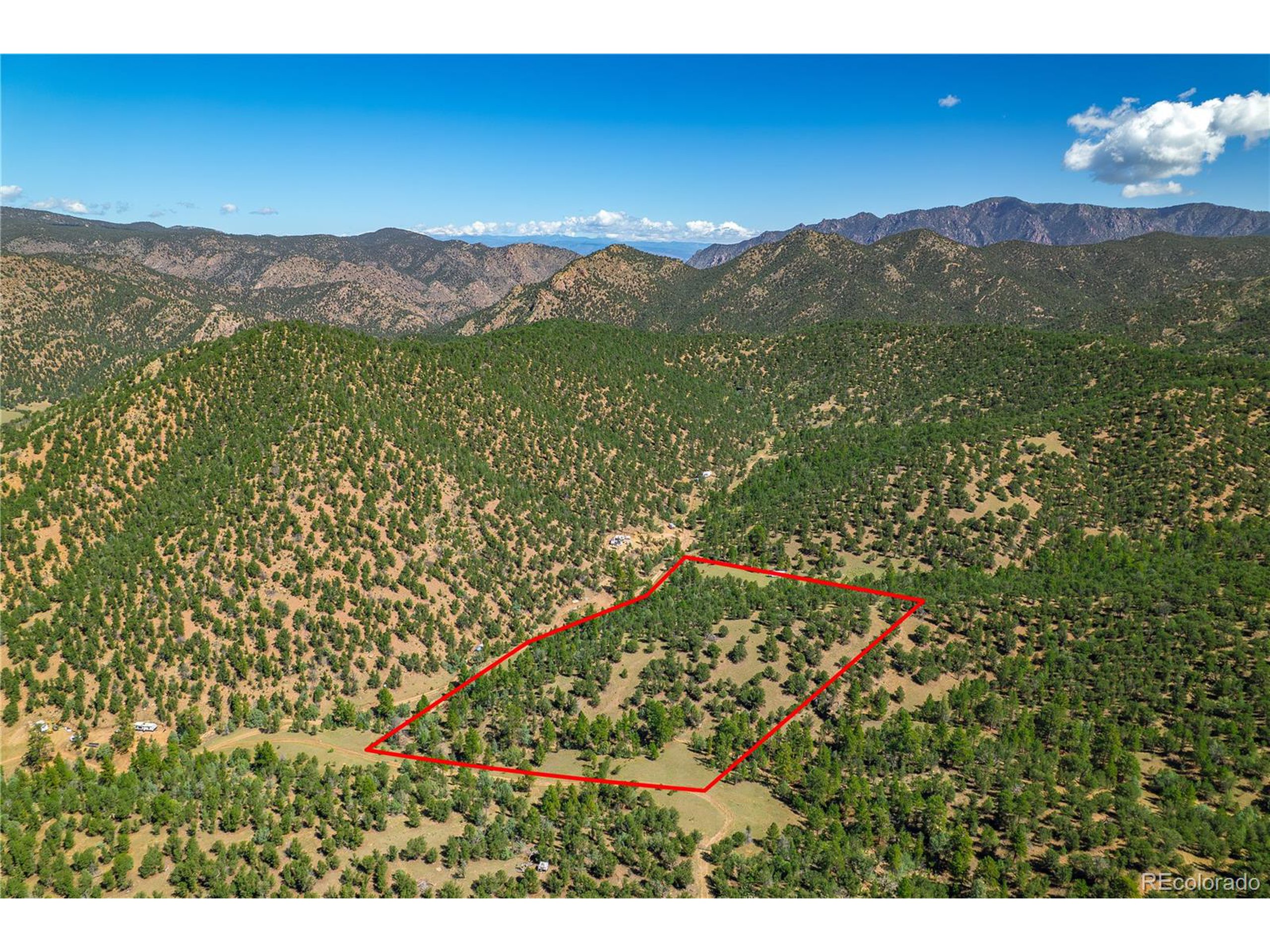 9 Sundance Road Cotopaxi, CO 81223 - Photo 2 of 32 a view of a lush green hillside and a building