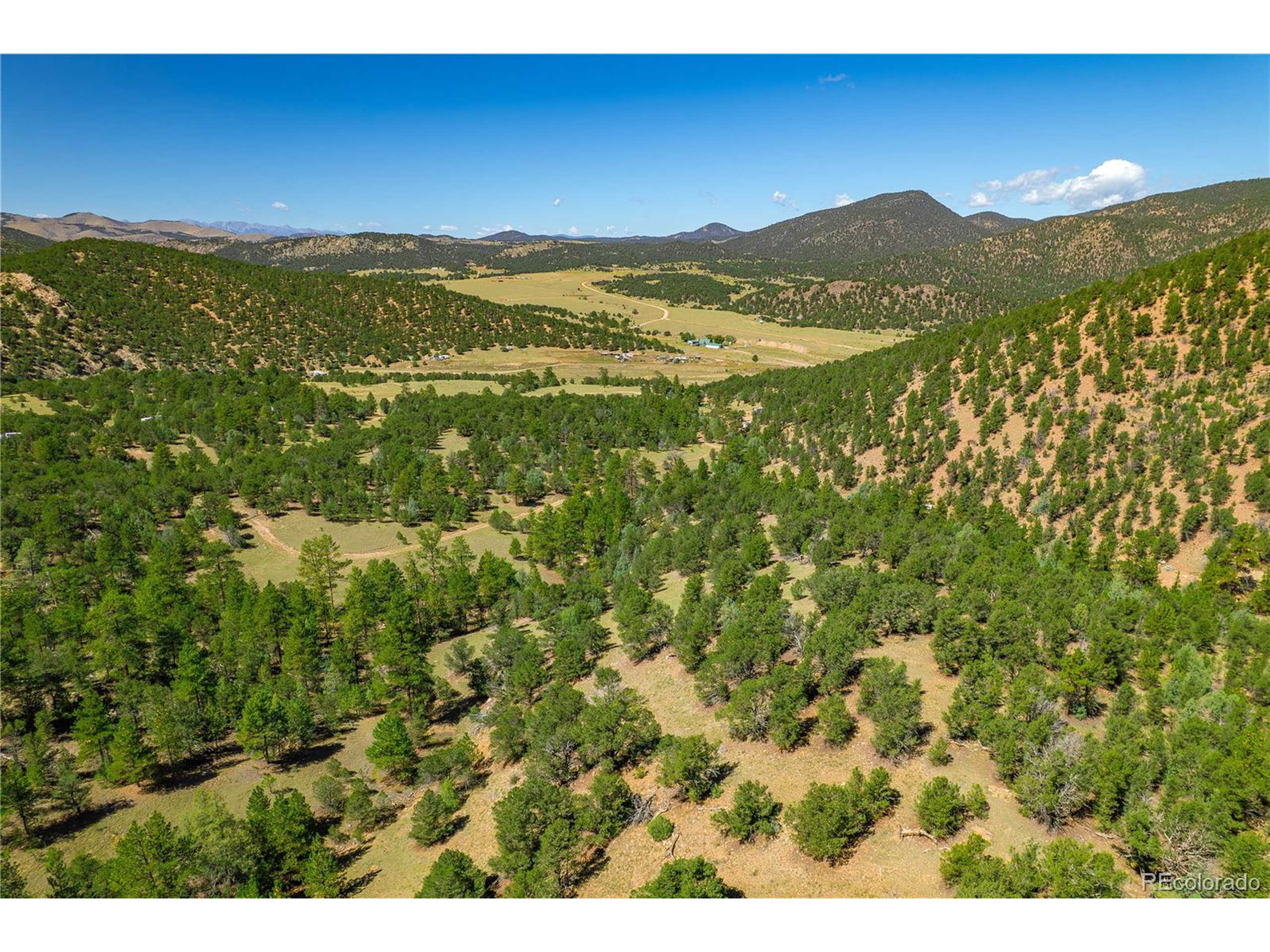 9 Sundance Road Cotopaxi, CO 81223 - Photo 24 of 32 a view of a mountain range with lush green forest