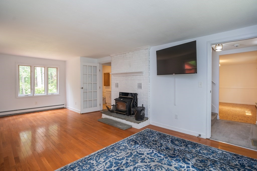 80 Goodell Street Belchertown, MA 01007 - Photo 21 of 40 a living room with a flat screen tv and a fireplace