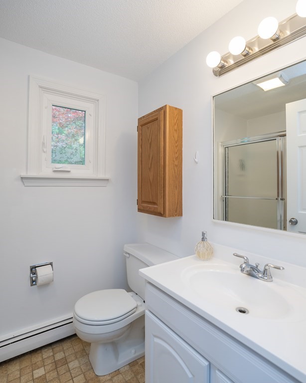 80 Goodell Street Belchertown, MA 01007 - Photo 25 of 40 a bathroom with a sink mirror vanity and toilet