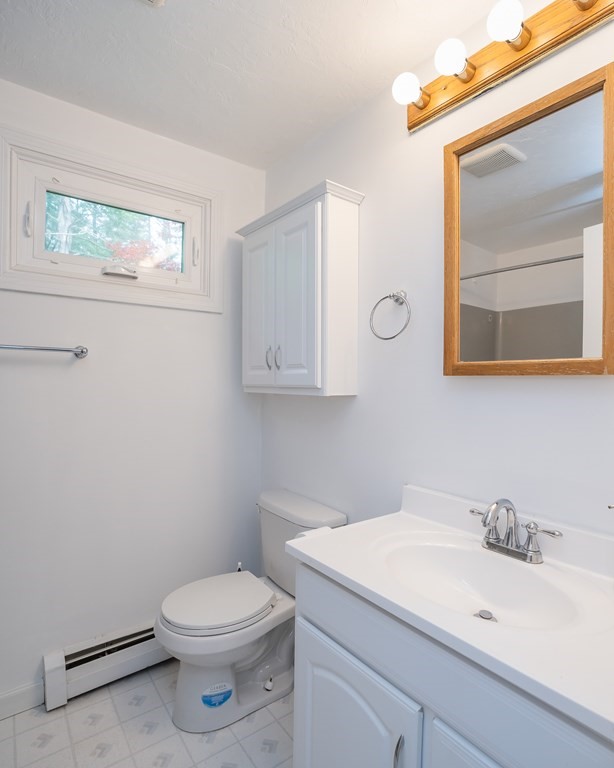 80 Goodell Street Belchertown, MA 01007 - Photo 31 of 40 a bathroom with a toilet a sink and mirror