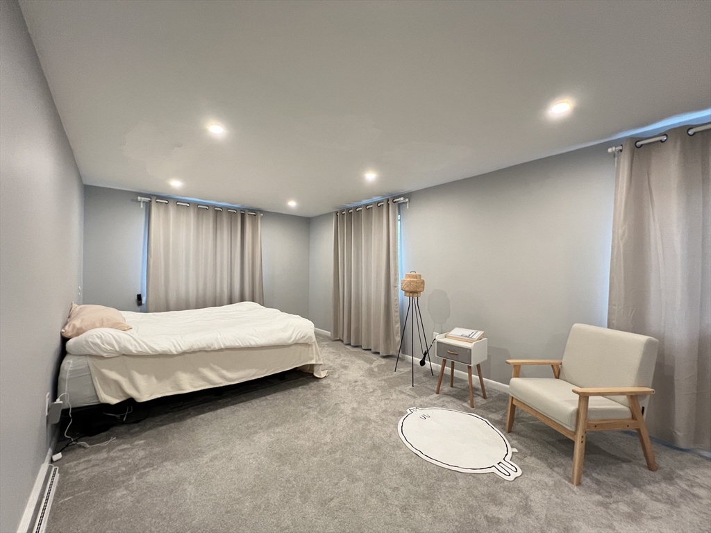 46 Suomi Road, Unit 46 Quincy, MA 02169 - Photo 11 of 16 a spacious bedroom with a bed and a chair
