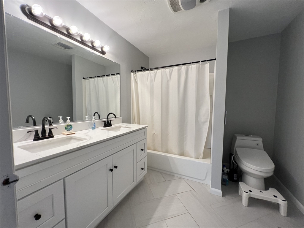 46 Suomi Road, Unit 46 Quincy, MA 02169 - Photo 13 of 16 a spacious bathroom with a double vanity sink and a toilet