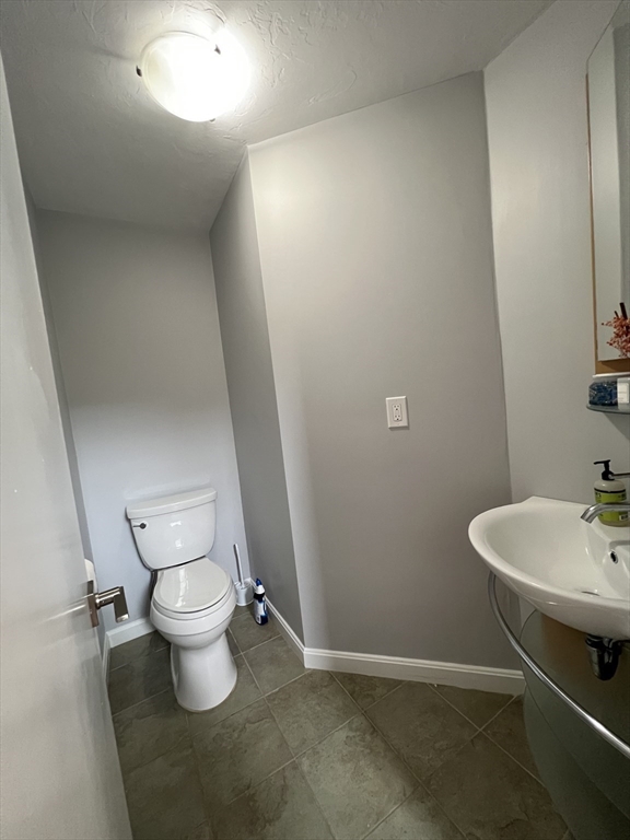 46 Suomi Road, Unit 46 Quincy, MA 02169 - Photo 15 of 16 a bathroom with a sink and a toilet