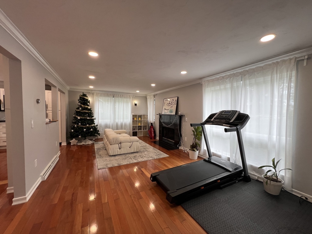 46 Suomi Road, Unit 46 Quincy, MA 02169 - Photo 5 of 16 a room with gym equipment and wooden floor