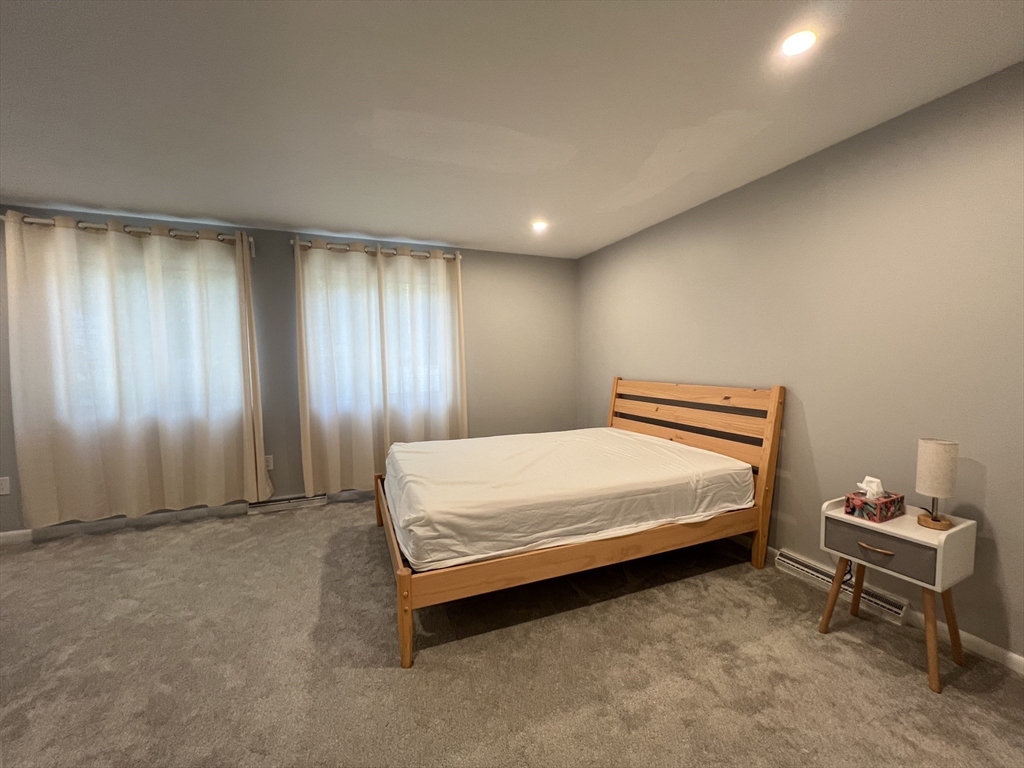46 Suomi Road, Unit 46 Quincy, MA 02169 - Photo 10 of 16 a bedroom with a bed and a window