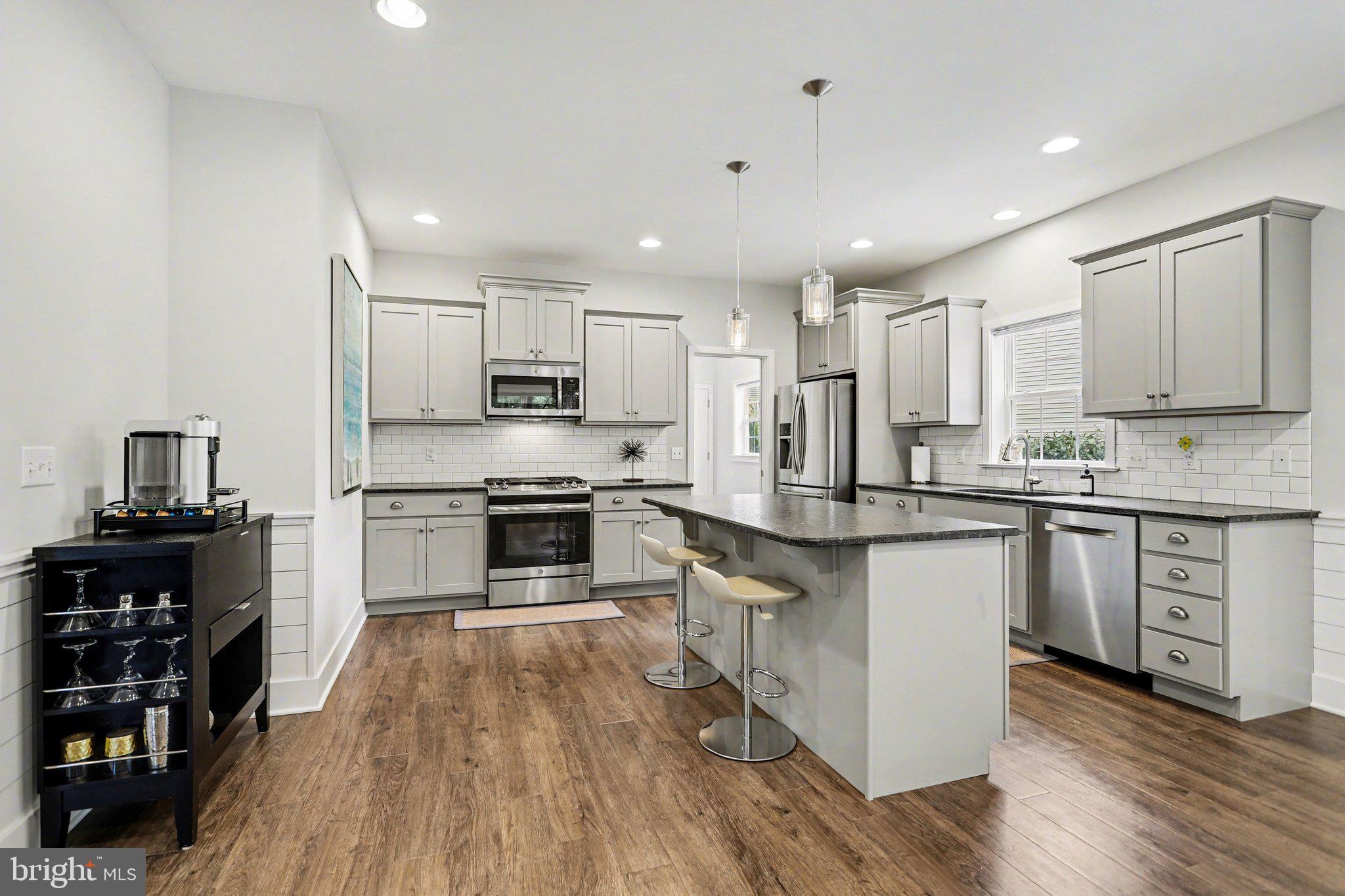 401 Wendover Way Lancaster, PA 17603 - Photo 11 of 45 a kitchen with granite countertop a stove top oven and cabinets