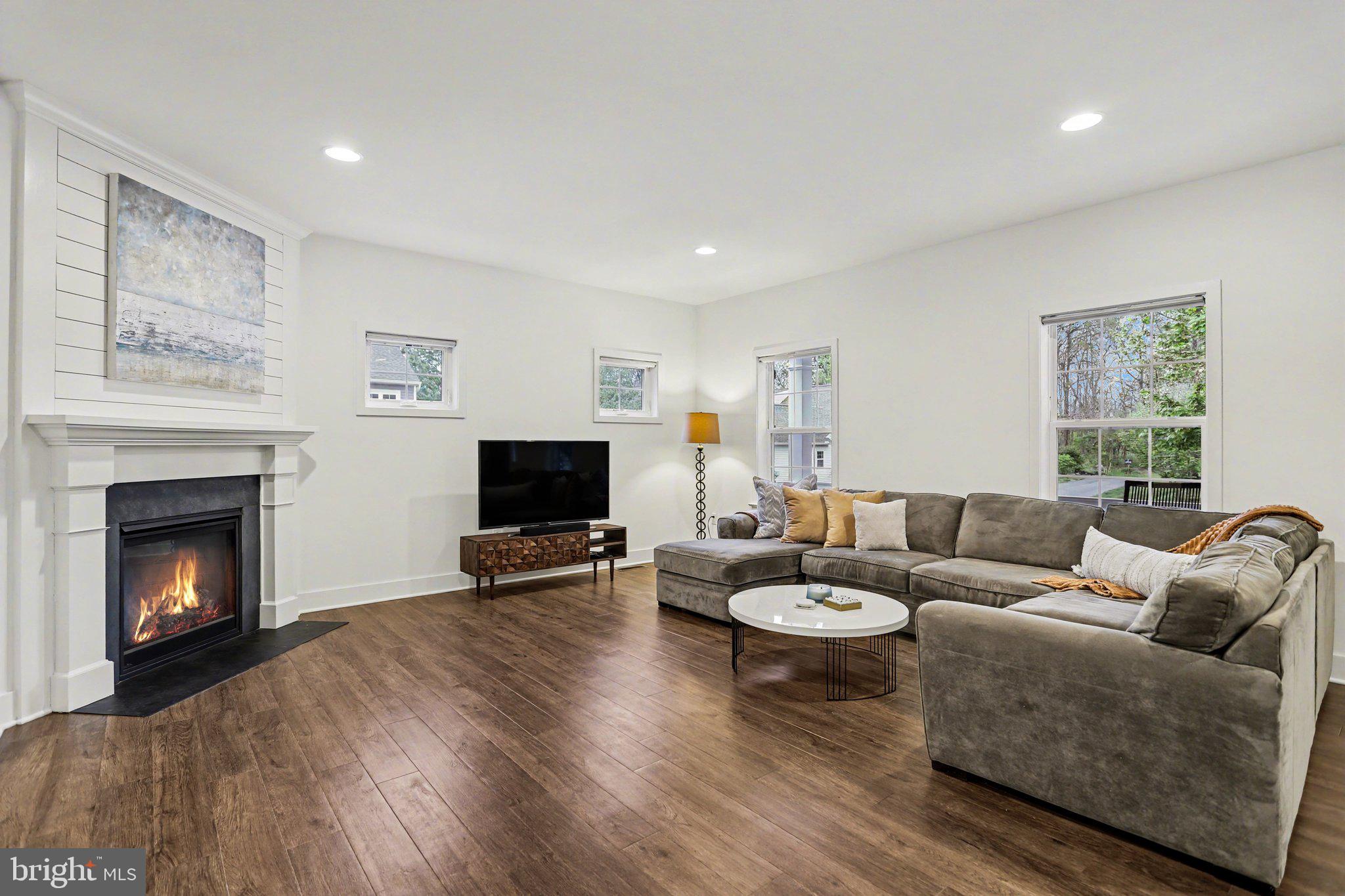 401 Wendover Way Lancaster, PA 17603 - Photo 10 of 45 a living room with furniture a fireplace and a flat screen tv