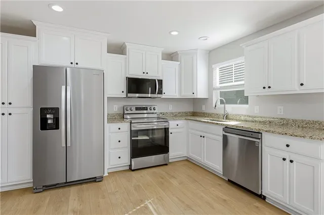 a view of a room with a ceiling fan and window