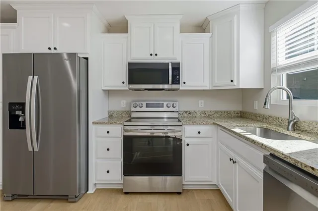 an empty room with closet and a chandelier fan