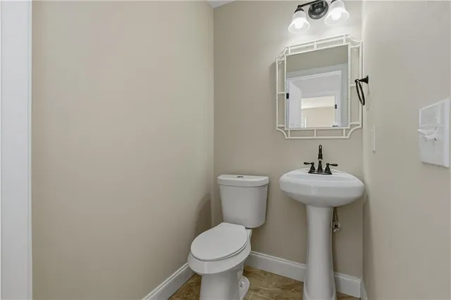 a bathroom with a granite countertop sink a mirror a vanity and a shower