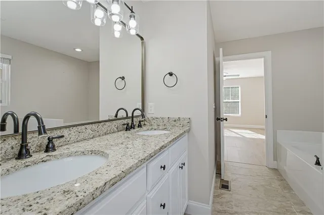 a bathroom with a granite countertop toilet sink and a mirror
