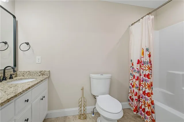 an empty room with a window and wooden floor