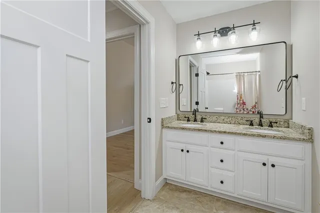 an empty room with fan and windows