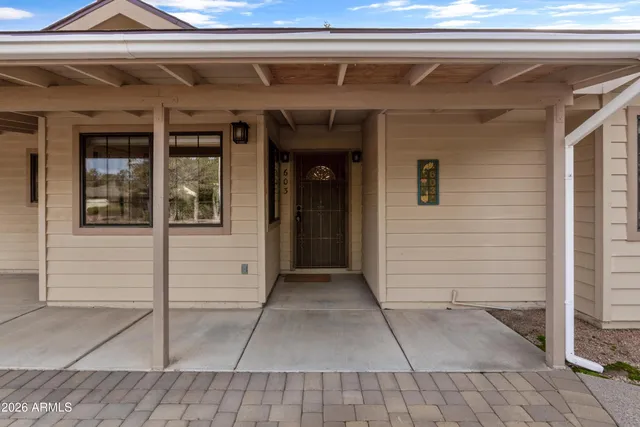 a view of a house with a garden and pathway