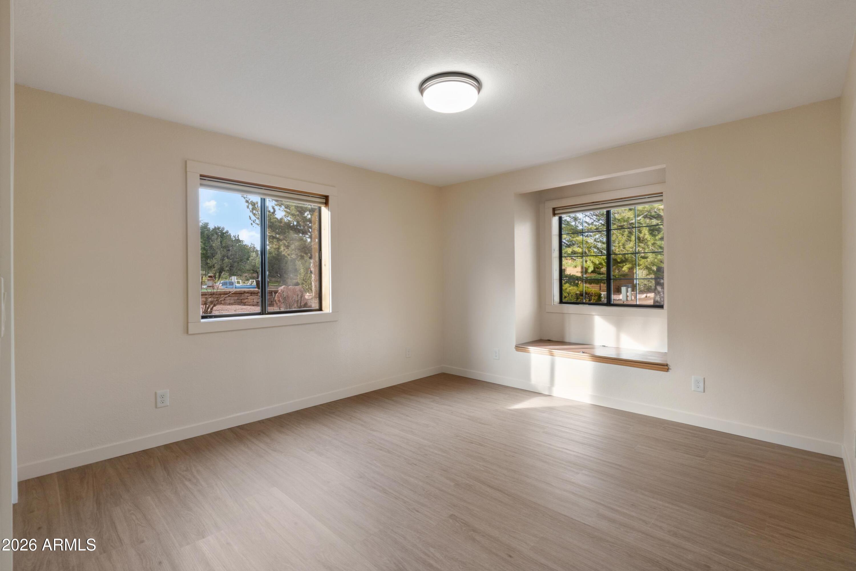 603 East Amarillo Circle Payson, AZ 85541 - Photo 13 of 54 an empty room with wooden floor and windows