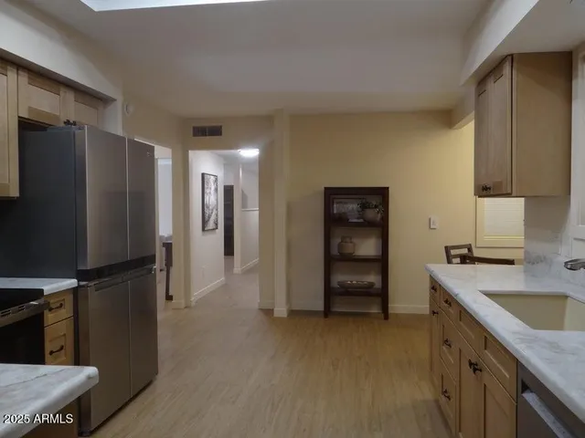 a kitchen with a refrigerator and a sink