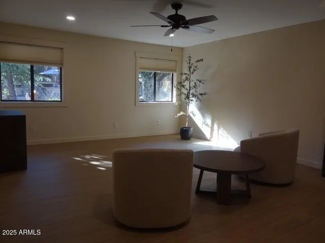 a workspace room with furniture and a window