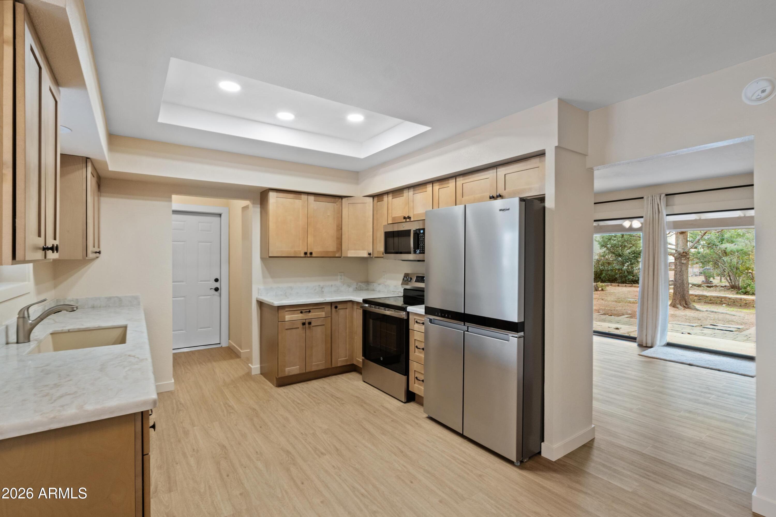 603 East Amarillo Circle Payson, AZ 85541 - Photo 30 of 54 a kitchen with a refrigerator sink and wooden floor