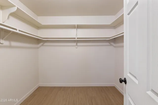 a backyard of a house with a tree and fence