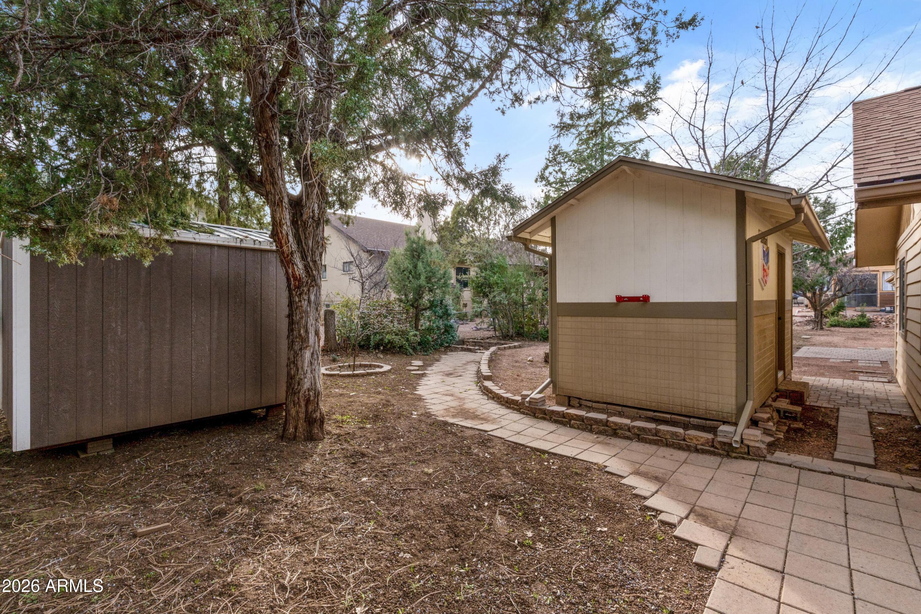 603 East Amarillo Circle Payson, AZ 85541 - Photo 44 of 54 a backyard of a house with a tree and fence