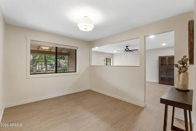 a view of a house with a yard potted plants and large tree
