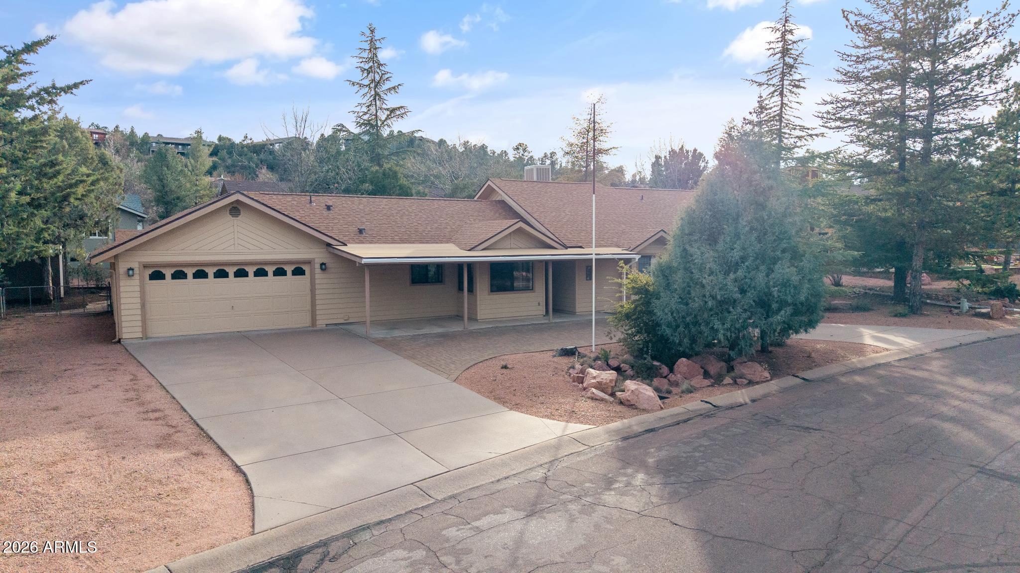 603 East Amarillo Circle Payson, AZ 85541 - Photo 9 of 54 a view of a house with a yard potted plants and large tree