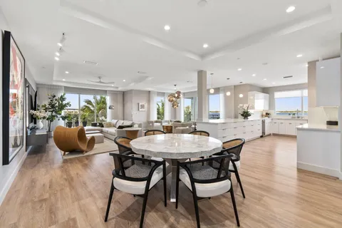 a living room with furniture a flat screen tv and a large window