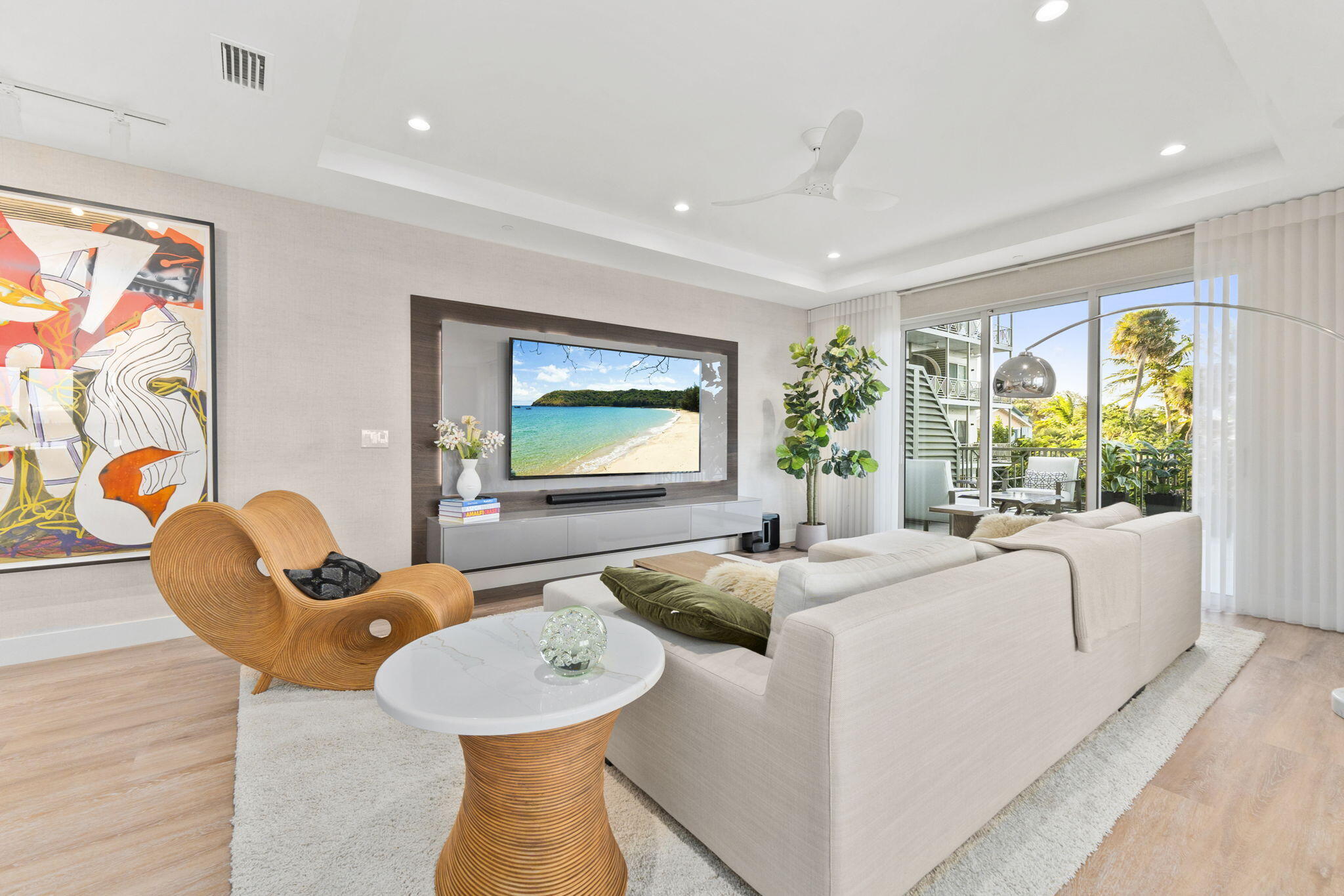 41 Southwest Seminole Street, Unit 206 Stuart, FL 34994 - Photo 18 of 72 a living room with furniture a flat screen tv and a large window