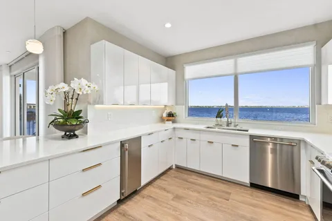 a kitchen with a refrigerator sink and cabinets