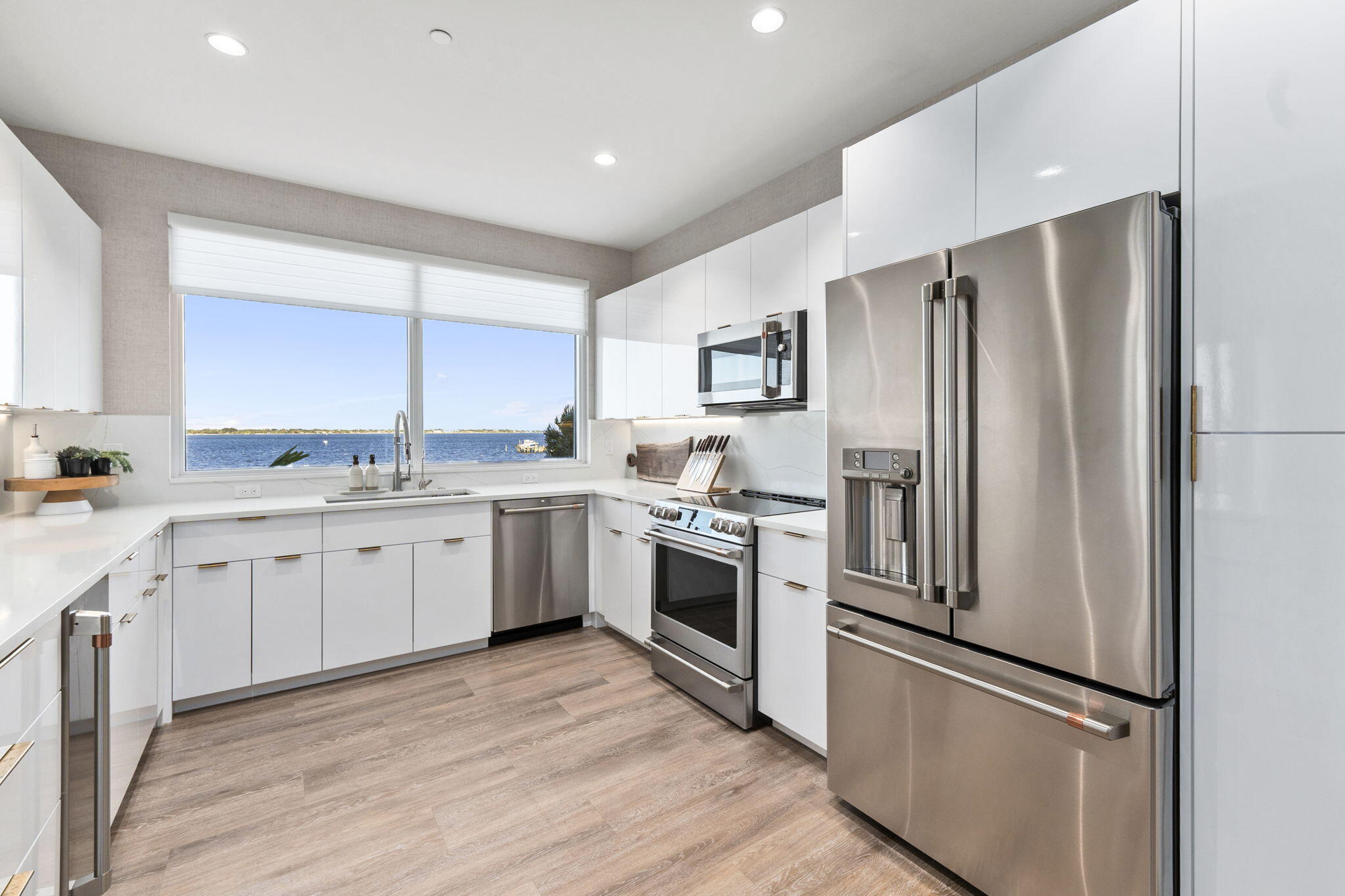 41 Southwest Seminole Street, Unit 206 Stuart, FL 34994 - Photo 24 of 72 a kitchen with a refrigerator sink and cabinets