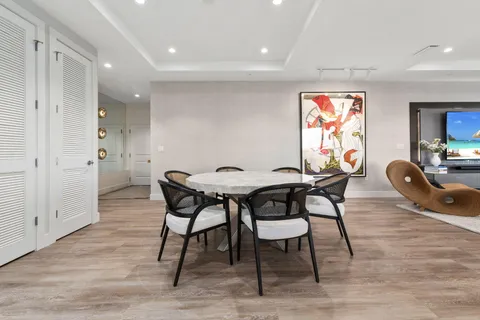 a bed sitting in a spacious bedroom next to a window