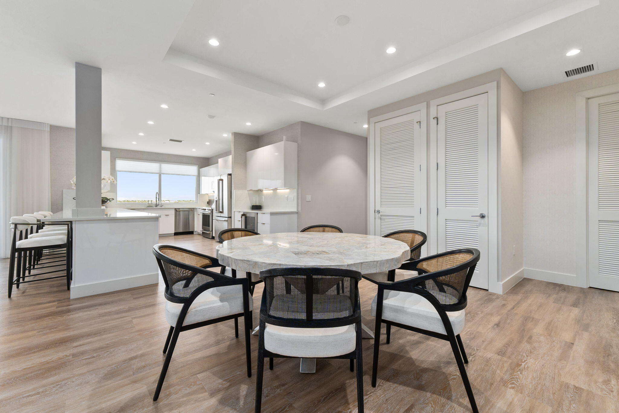 41 Southwest Seminole Street, Unit 206 Stuart, FL 34994 - Photo 28 of 72 a view of a a dining room with furniture window and wooden floor