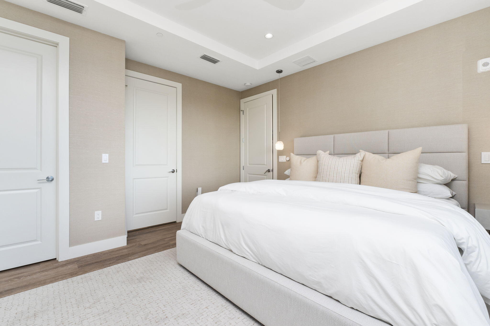 41 Southwest Seminole Street, Unit 206 Stuart, FL 34994 - Photo 38 of 72 a bedroom with a bed and a night stand