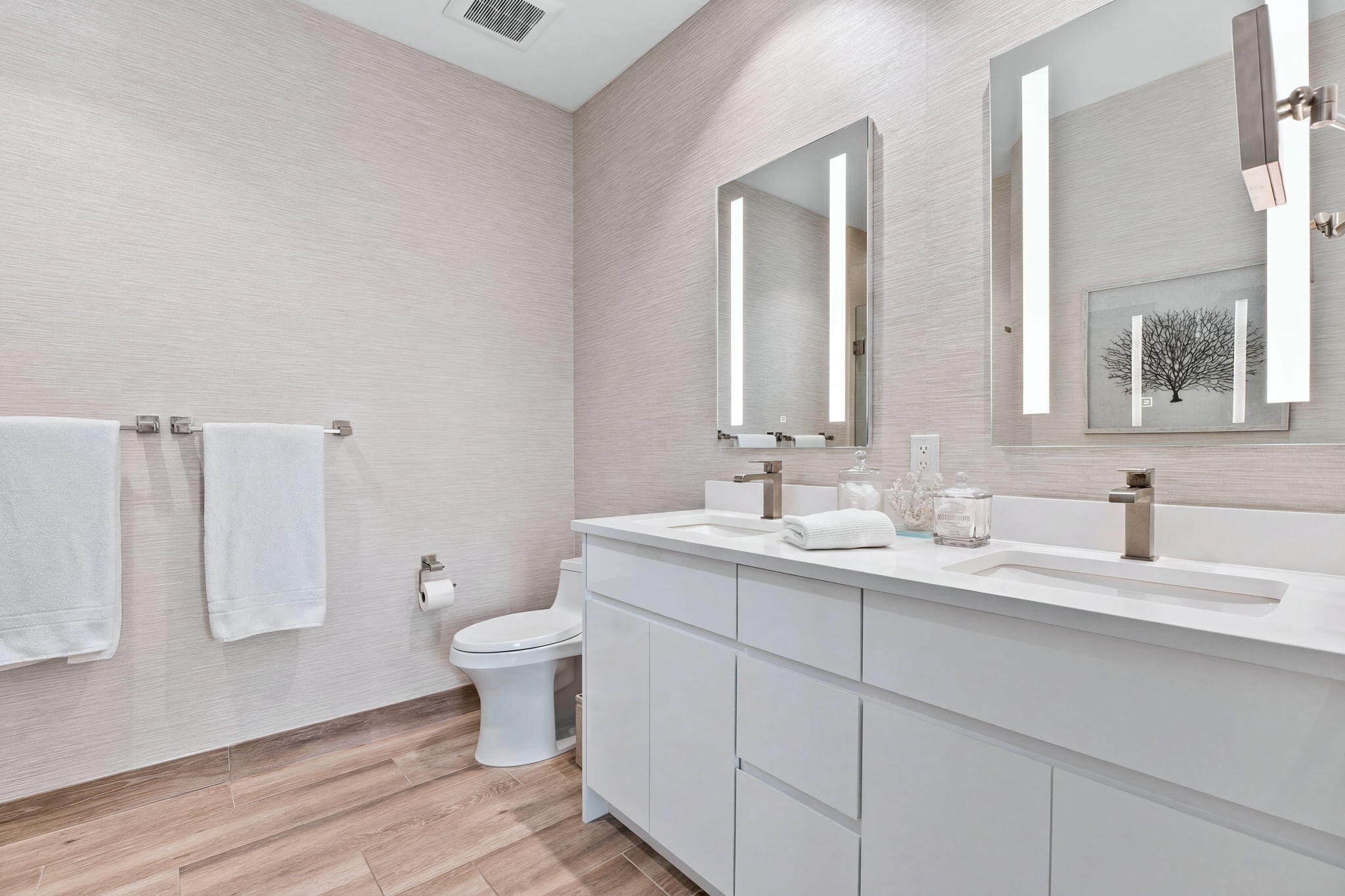 41 Southwest Seminole Street, Unit 206 Stuart, FL 34994 - Photo 41 of 72 a bathroom with a toilet sink and mirror