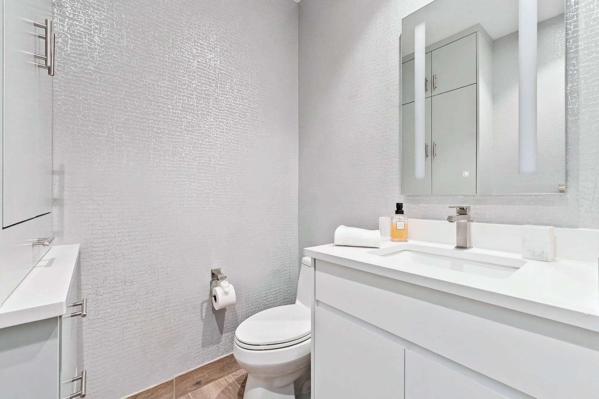 41 Southwest Seminole Street, Unit 206 Stuart, FL 34994 - Photo 47 of 72 a bathroom with a sink toilet and a mirror