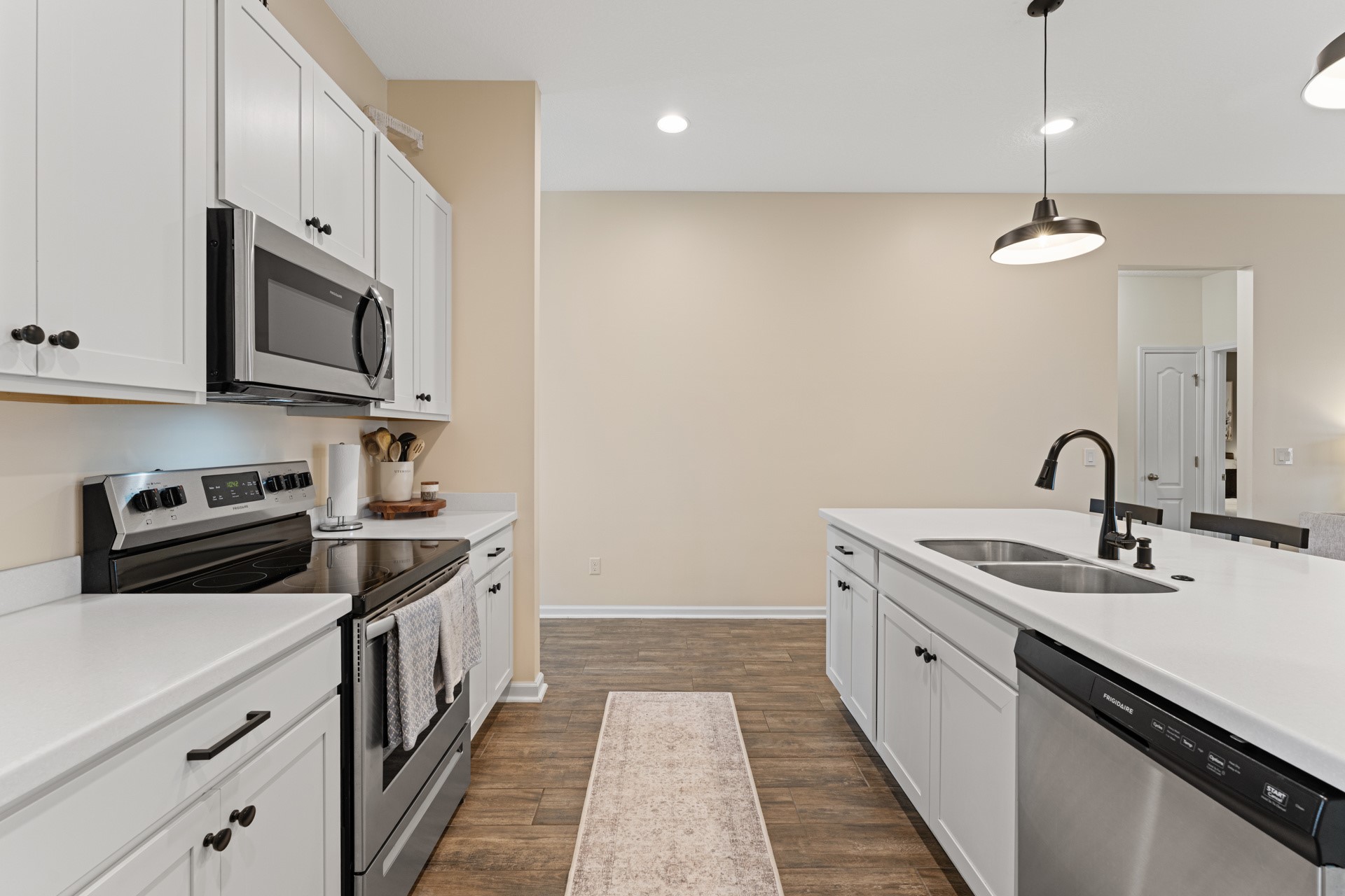 86645 Lazy Lake Circle Yulee, FL 32097 - Photo 14 of 44 a kitchen with stainless steel appliances granite countertop a sink a stove and a refrigerator